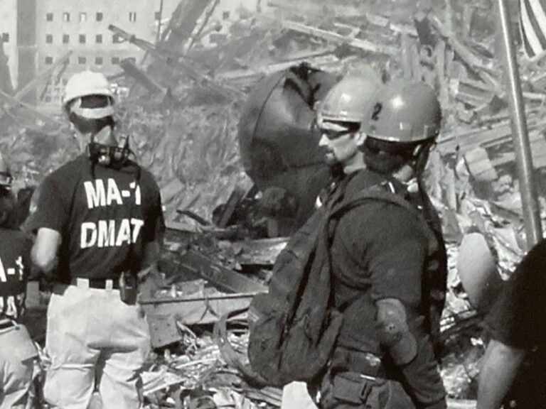 A black and white photo of rescuers at ground zero
