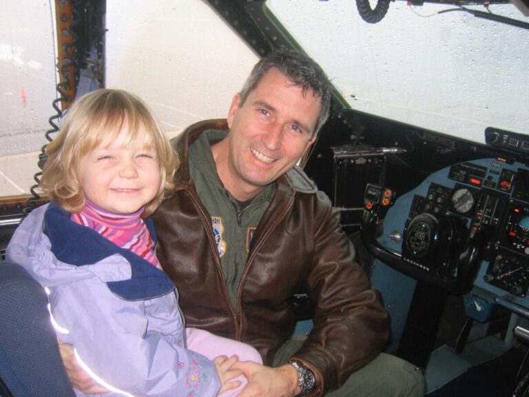 Beirne as a young girl sitting in her father's cockpit with him