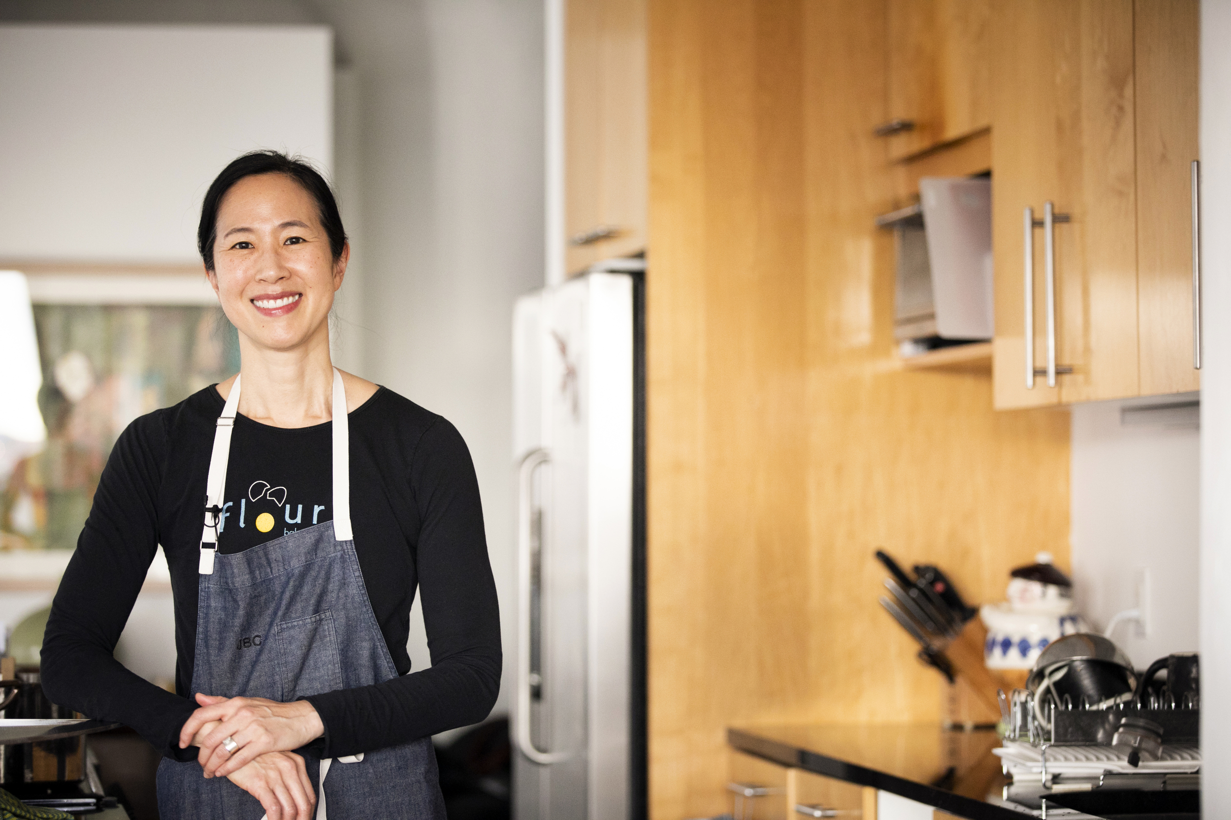 Joanne Chang wears an apron in a kitchen